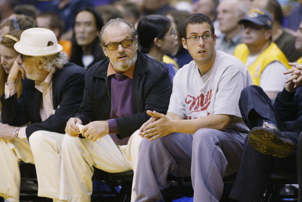 Actors Jack Nicholson and Adam Sandler watch the game