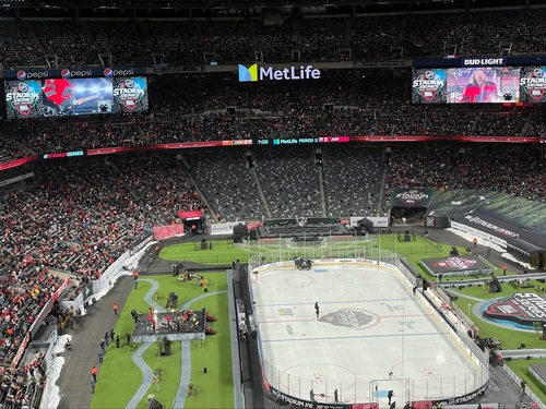 overview of MetLife stadium with the gaslight anthem performing on a small stage