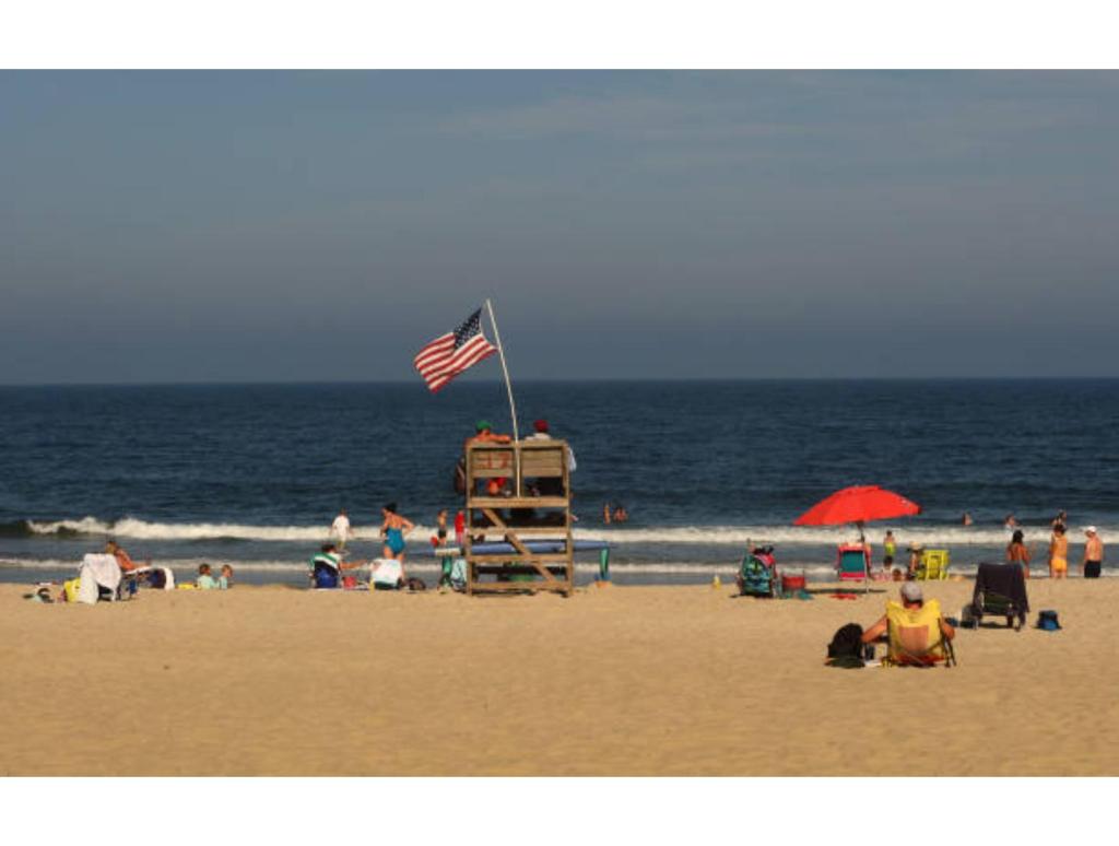 Bradley Beach Lifeguards Saved Swimmer. SPRING LAKE, NJ - JULY 6: Lifeguards look out from their tower on the beach as people swim in the ocean on July 6, 2023, in Spring Lake, New Jersey.