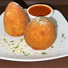 2 Arancini with sauce on a plate 