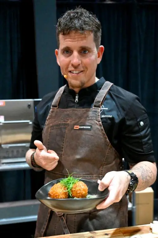 Chef holding arancini